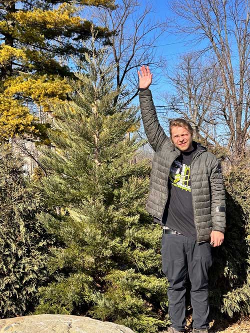 Jesse next to Giant Sequoia planted in Detroit in 2024